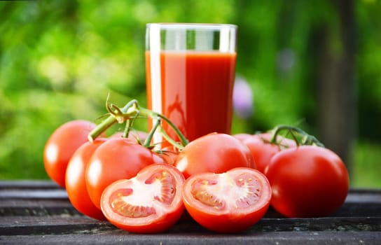 Tomatoes and juice in the garden. Organic food.