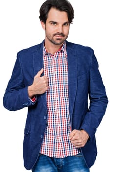 Young man in trendy casual look with dark hair and beard isolated against a white background
