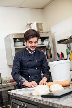 young chef throwing dough pizzadough pizza baker in the restaurant kitchen