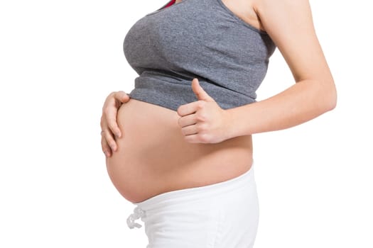 Young woman with baby belly in expectant posture as close-up isolated against white background