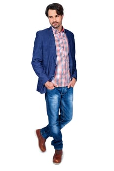 Young man in trendy casual look with dark hair and beard isolated against a white background