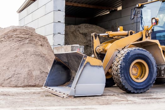 Shovel loader wheel loader with large shovel in the construction industry in the open air in daylight
