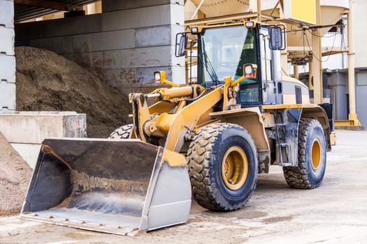 Shovel loader wheel loader with large shovel in the construction industry in the open air in daylight