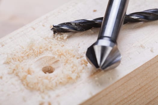 Cordless screwdriver in a carpentry shop with drill and sinker as a detailed recording for do-it-yourselfers