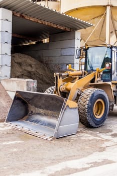 Shovel loader wheel loader with large shovel in the construction industry in the open air in daylight