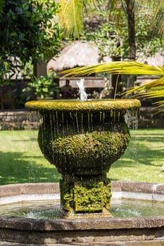 Fountain in an artificial garden in summer in Bali