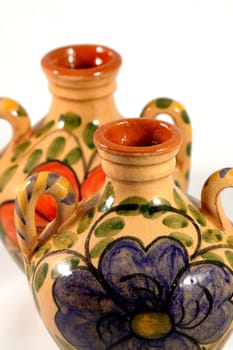 Ceramic pot with flower painting over white