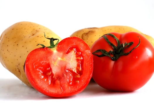 Two potatoes and sliced tomatoes put together