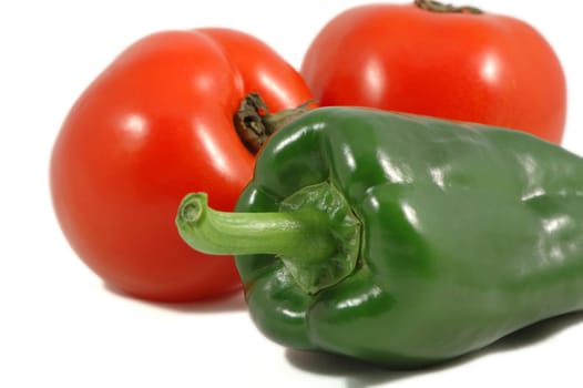 Green paprica and red tomatoes over white