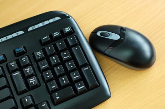 Black wirel keyboard and mouse on desk