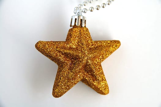 A yellow ornamental christmas star with white background