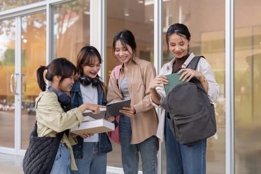 Happy young student chat with each other after class. Guy and girls wear casual clothes to study. Lifestyle concept, sincere emotions.