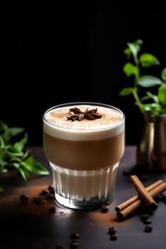 Glass of tasty Brown Butter autumn latte macchiato coffee on dark background. Fall and winter warm drinks concept