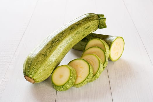fresh vegetable zucchini sliced on wooden background