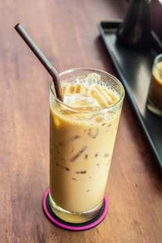 Iced coffee on the wooden table in coffee cafe.
