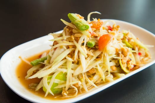 Green papaya salad on the table in the restaurant.
