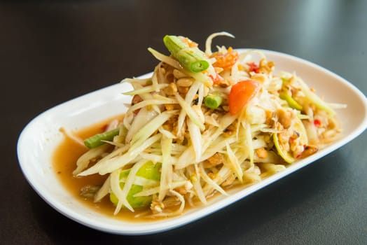 Green papaya salad on the table in the restaurant.