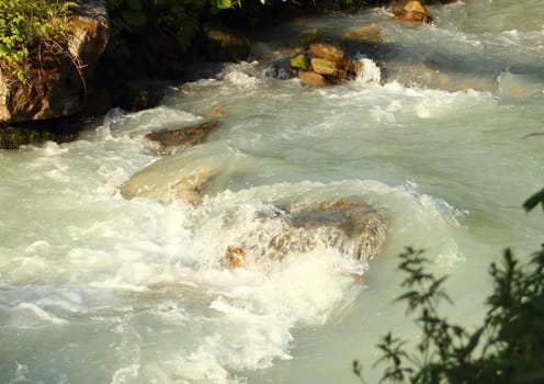 Small brook with clear white melting water
