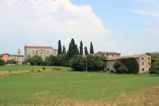 View over church and abandon vineyard in Italy