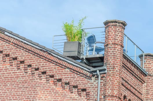 Beautiful renovated old building facade with an Idiylian roof terrace.