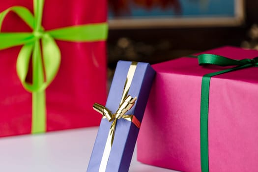 Three gift boxes wrapped in unicolored papers