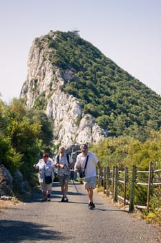 Portrait of happy elderly tourists walking on the Rock of Gibraltar.