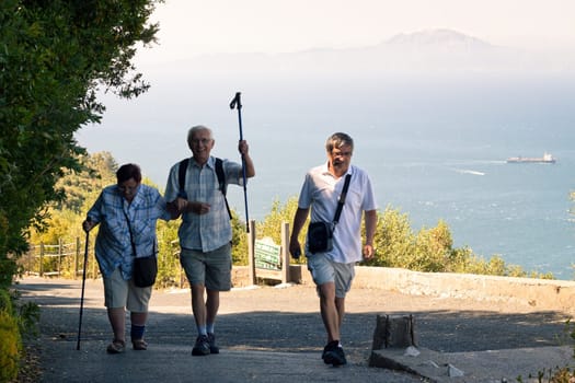 Portrait of happy elderly tourists walking on the Rock of Gibraltar.
