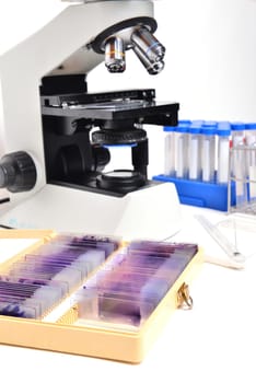 microscope with laboratory equipment on white background