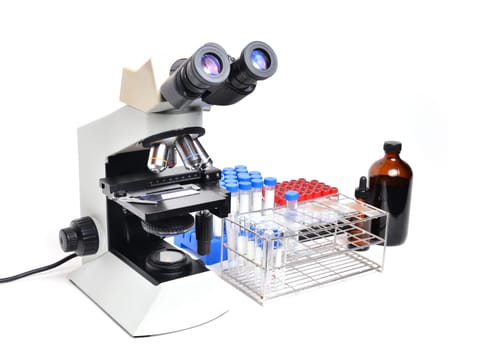 microscope with laboratory equipment on white background