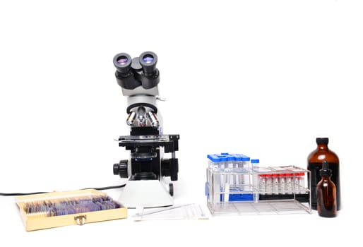 microscope with laboratory equipment on white background