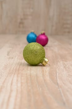 Christmas baubles on a rustic wooden background