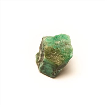 A raw uncut piece of emerald shot over white.