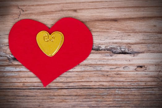 Two Hearts, a Red and a Golden One, on a Wooden Plank