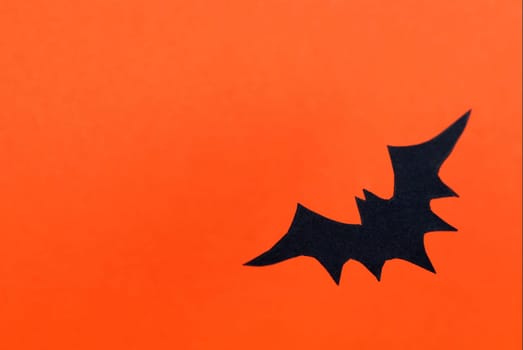 Orange Halloween Background with Black Bat and Copy Space