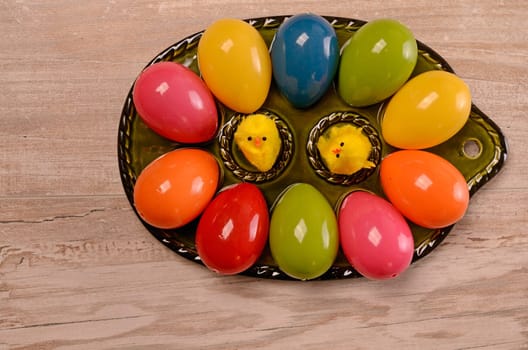 Colorful Easter eggs on a green ceramic plate