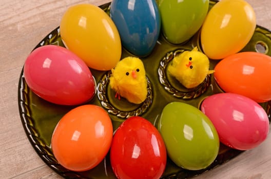 Colorful Easter eggs on a green ceramic plate