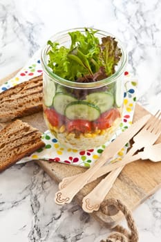 Layered salad with fresh mud in the mason jar