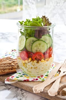 Layered salad with fresh mud in the mason jar