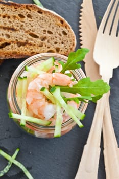 Fresh shrimp salad with dressing in a mason jar