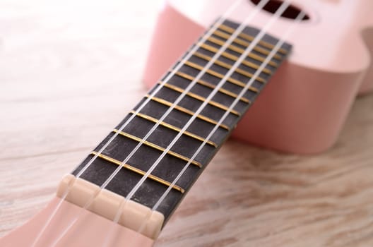 Closeup of a pink ukulele