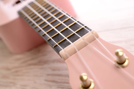 Closeup of a pink ukulele