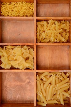 Old wooden box with pasta ingredients