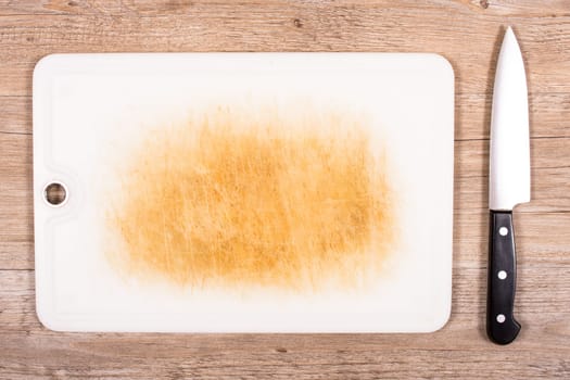 Cutting board and knife on a wooden table