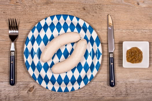 Cover in the beer garden with white sausages and sweet mustard