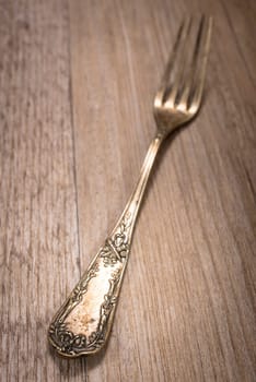 Decorations on a silver fork on a wooden table