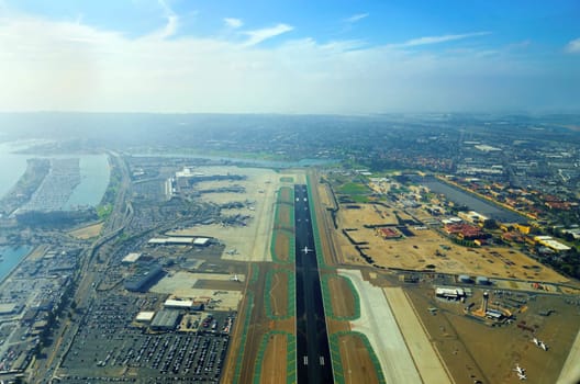 Aerial view of the San Diego International Airport, river and pacific ocean, in Southern California. Lindbergh Field is the busiest single runway commercial airport in the United States of America.