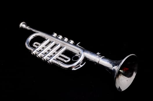 Silver Vintage Toy Trumpet on a Black Background