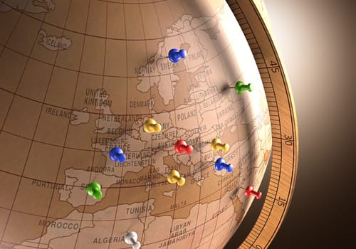 Antique globe with nails marking the travel route.