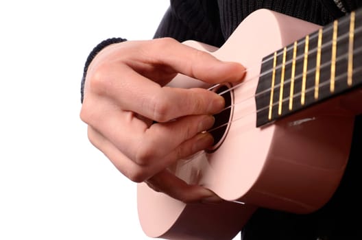 A man is playing with an ukulele