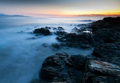 Beautiful sunset on the sea - rocky coast